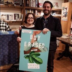 Maud Newton and Garrard Conley stand behind a large poster of Boy Erased at the launch for the book at Book Court in Brooklyn, in May 2016