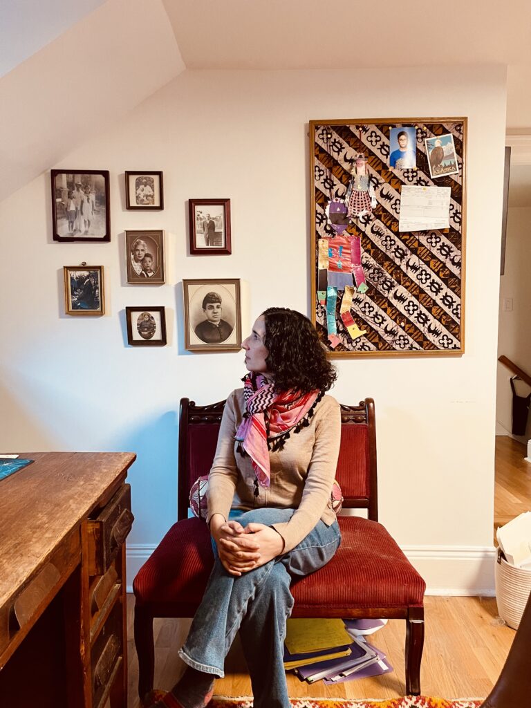 The writer Emily Raboteau, seated, looks at her ancestor wall.